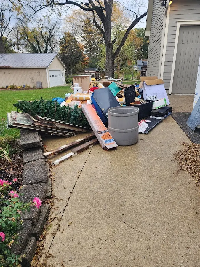 Dumpster being loaded with debris for Estate Cleanout Dumpster Rental in East Camden